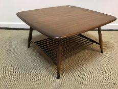 An Ercol elm coffee table of rounded square form on turned legs united by a magazine rack undertier,