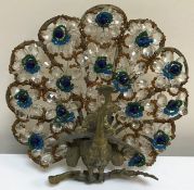 A set of three 20th Century cast brass and cut glass decorated peacock wall sconces,