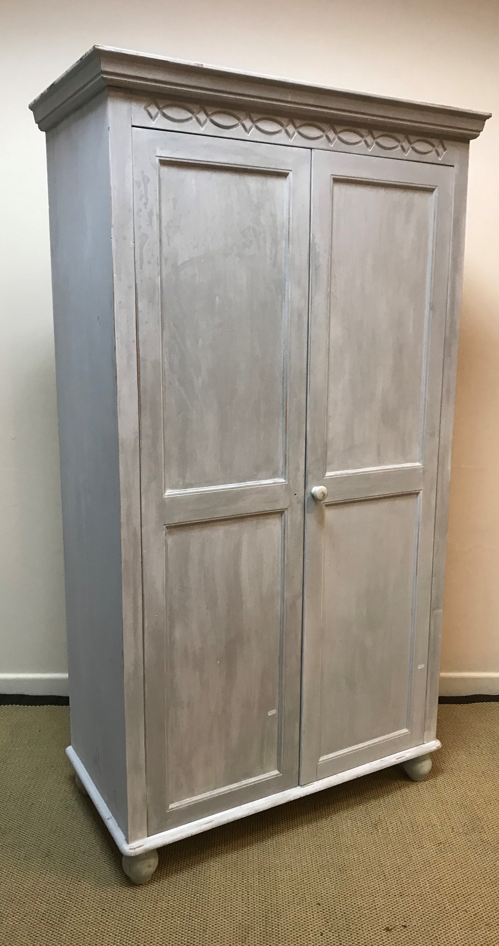 Two modern painted pine two door wardrobes, one with shelf and hanging rail,