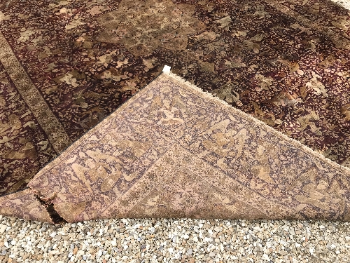 An early 20th Century Agra North India carpet with centre medallion on a wine-coloured ground, - Image 100 of 103