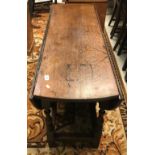 An 18th Century oak oval gate-leg drop-leaf dining table,