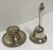 An early 20th Century silver capstan inkwell of small proportions with weighted base and clear