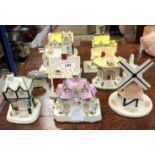A collection of nine Coalport cottage ornaments, including "The Old Curiosity Shop",