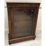 A Victorian walnut and marquetry inlaid single glazed door side cabinet on turned feet, 74.