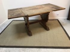 An early 20th Century walnut draw leaf extending dining table,