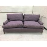 A modern mauve upholstered two seat sofa on square tapered legs,