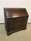 An 18th Century oak and walnut strung bureau,