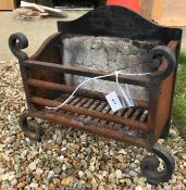 A 20th Century wrought iron fire basket with integral fire brick back and scrollwork decoration,