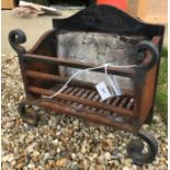 A 20th Century wrought iron fire basket with integral fire brick back and scrollwork decoration,