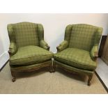 A pair of circa 1900 stained beech-framed wing back show frame armchairs in the Louis XV taste,