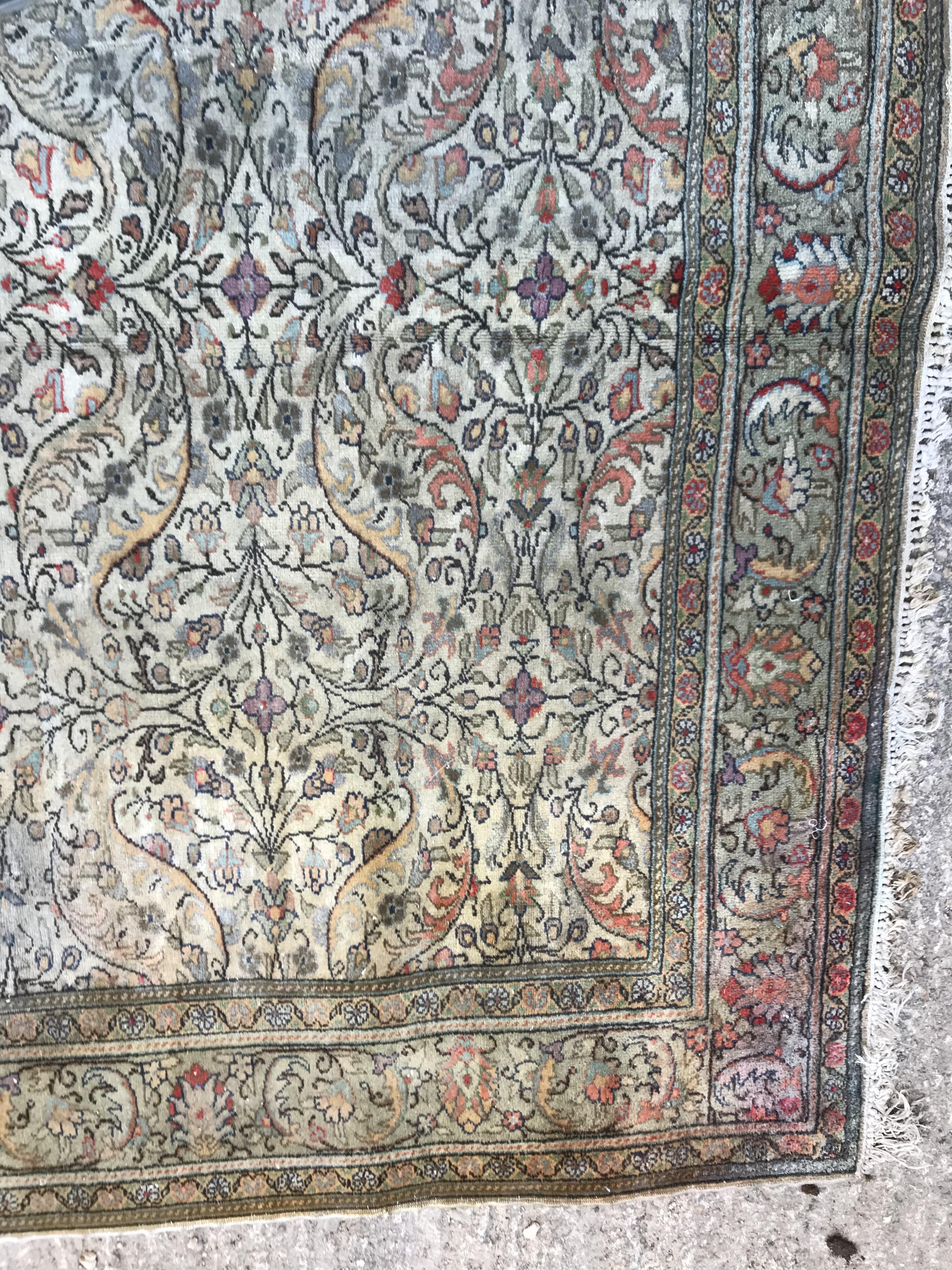 An Oriental carpet, the central panel set with all over floral decoration on a fawn ground, - Image 7 of 11