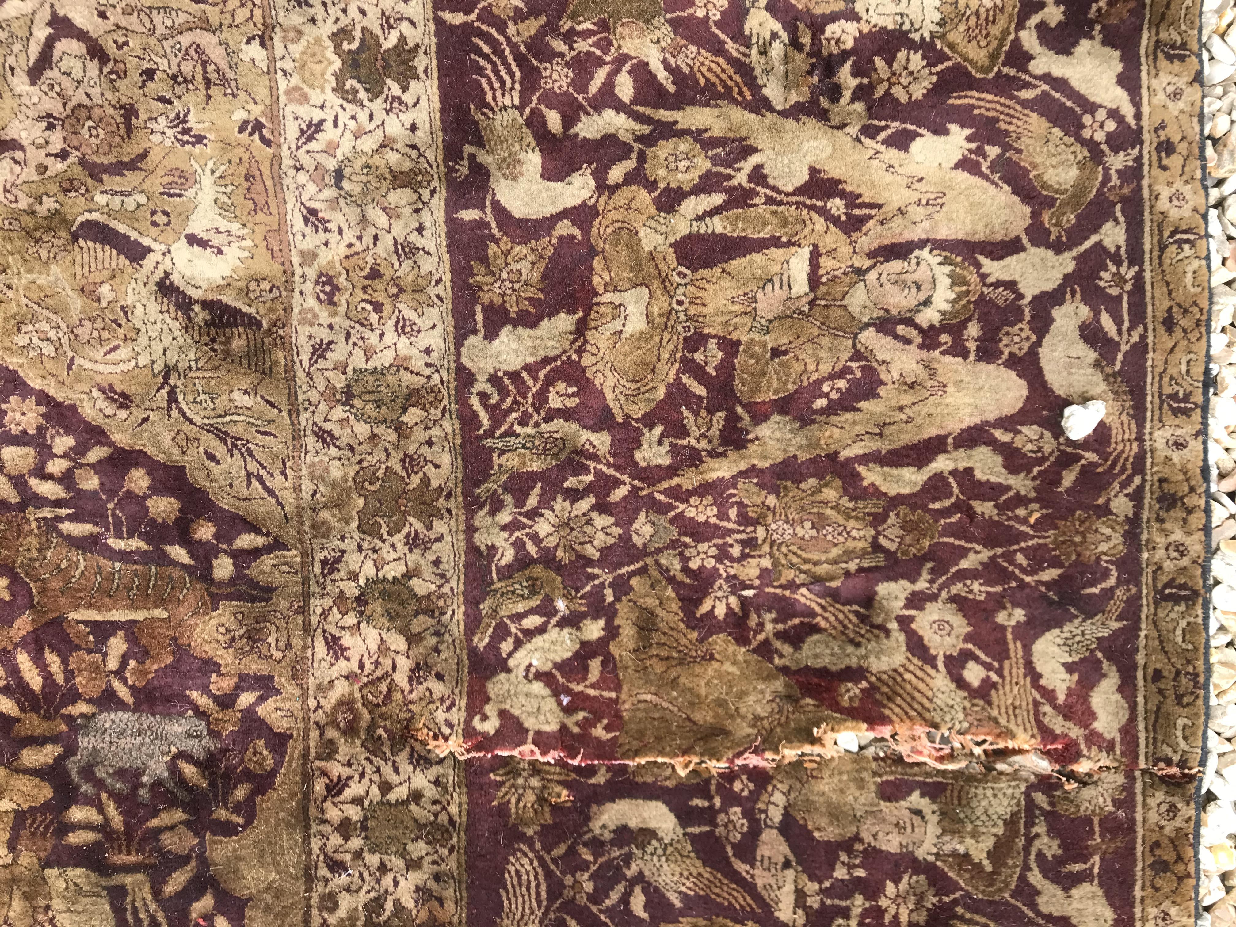 An early 20th Century Agra North India carpet with centre medallion on a wine-coloured ground, - Image 64 of 103