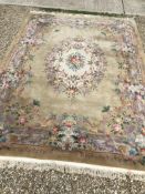 A Chinese superwash rug with central floral cream ground medallion on a gold ground,