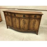 A Bevan Funnell Reprodux serpentine fronted sideboard in the George III manner with three drawers