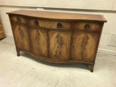 A Bevan Funnell Reprodux serpentine fronted sideboard in the George III manner with three drawers