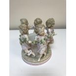 A Continental jardinere/pot decorated with dancing children wearing floral spray,