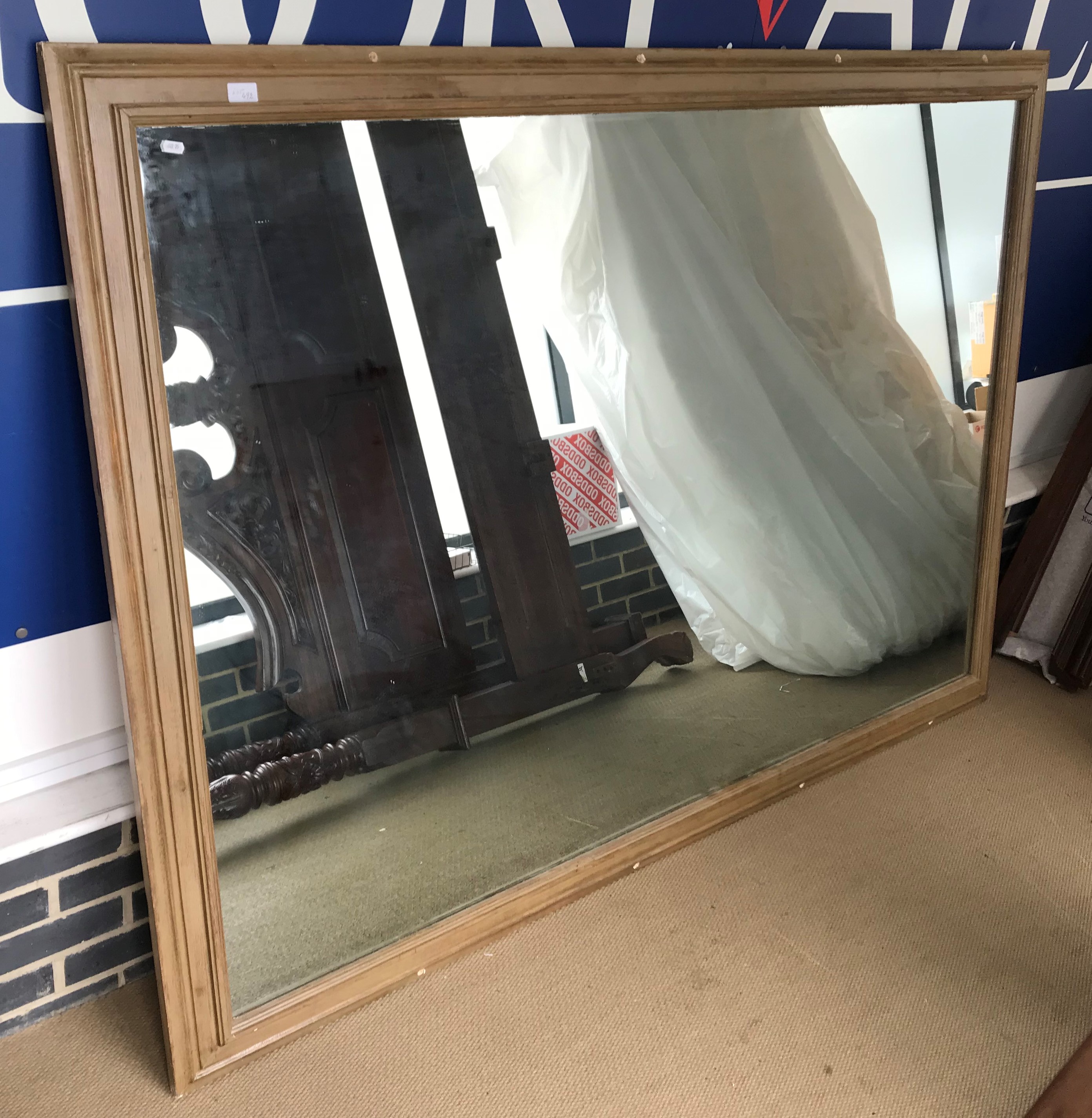 A large rectangular gilt-framed wall mirror (frame with new drill holes)