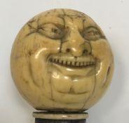 A 19th Century Japanese Meiji Period carved ivory stick or cane handle as a smiling head with