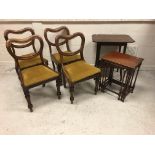 An early 20th Century mahogany nest of three occasional tables on turned legs united by stretchers,