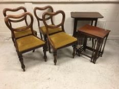 An early 20th Century mahogany nest of three occasional tables on turned legs united by stretchers,