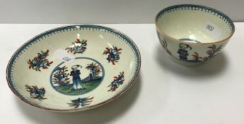 A Caughley tea bowl and saucer circa 1775, polychrome painted in the "Waiting Chinaman" pattern,