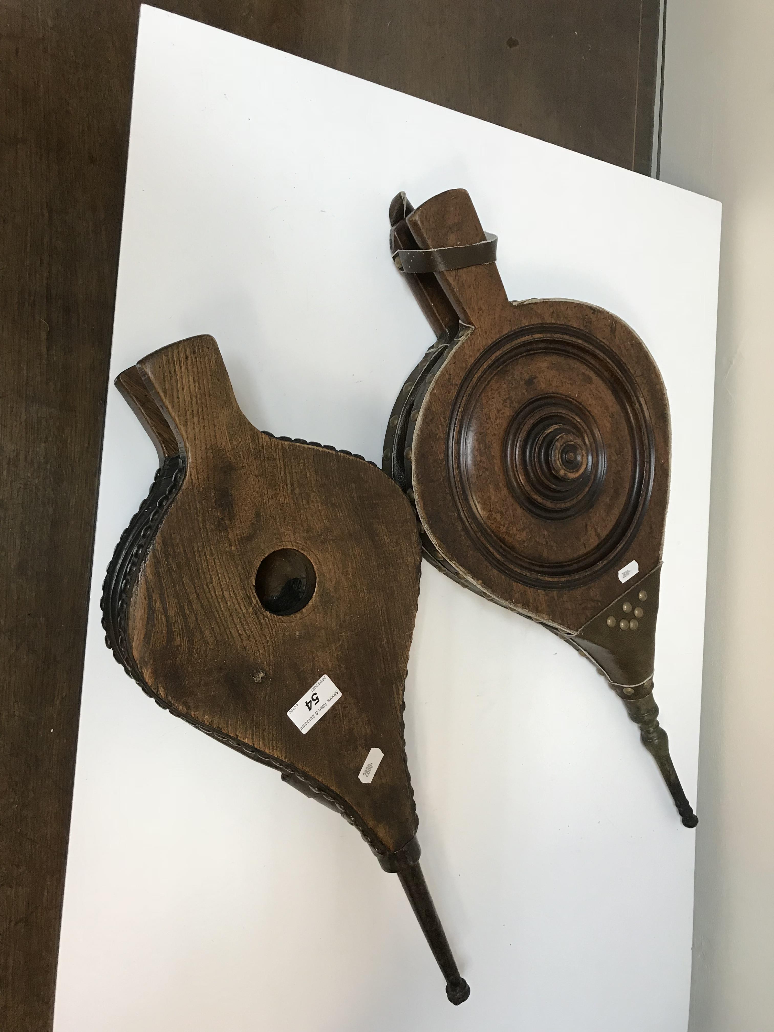 A pair of 19th Century walnut and leather bellows and another pair in oak