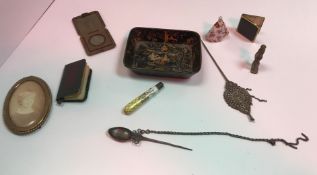 A collection of various objets de vertu, including photograph frames, spike spoons,