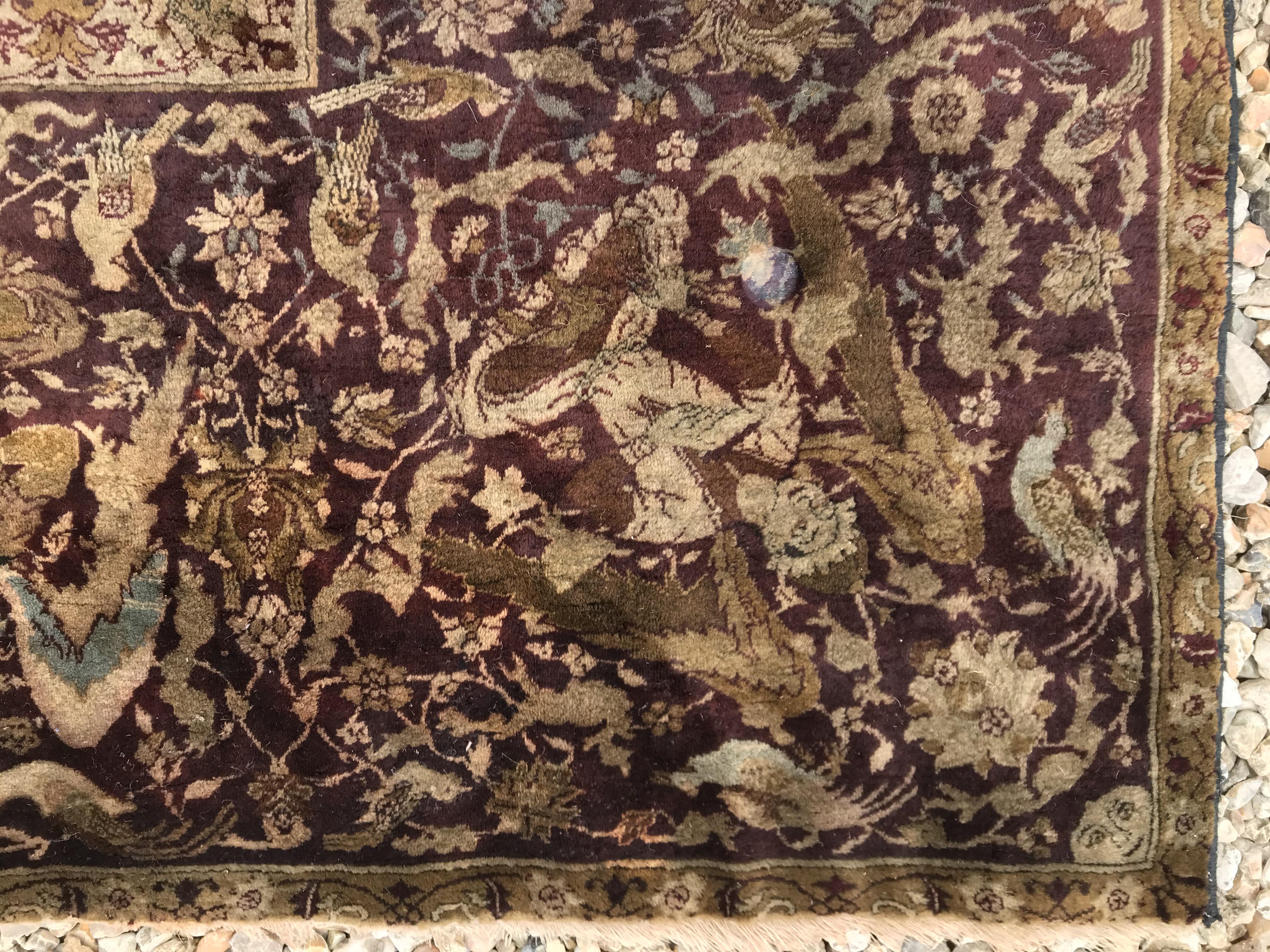 An early 20th Century Agra North India carpet with centre medallion on a wine-coloured ground, - Image 12 of 103