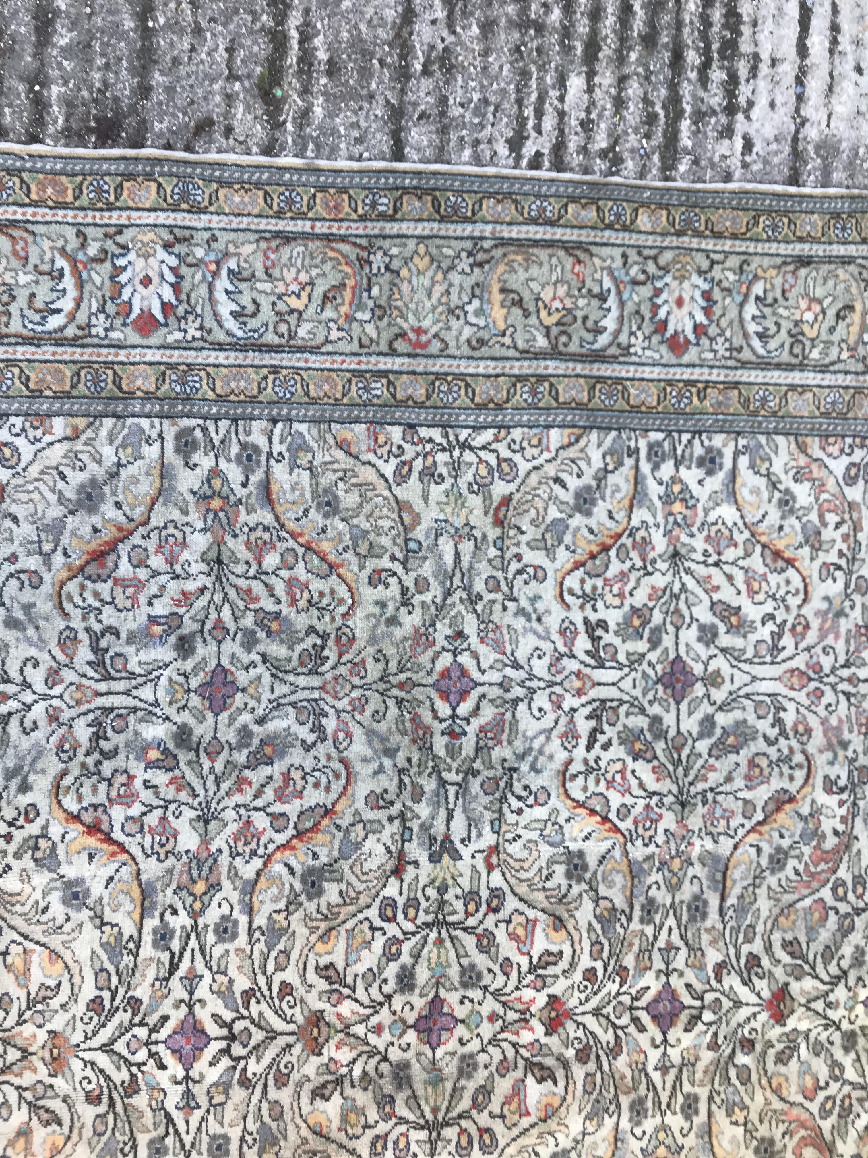 An Oriental carpet, the central panel set with all over floral decoration on a fawn ground, - Image 6 of 11