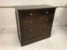 A circa 1900 stained beech chest of two short over three long drawers on a plinth base,