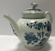An 18th Century Worcester bullet-shaped teapot decorated with two birds and fence pattern both