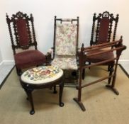 A pair of Carolean style carved oak dining chairs on bobbin supports with upholstered back panel