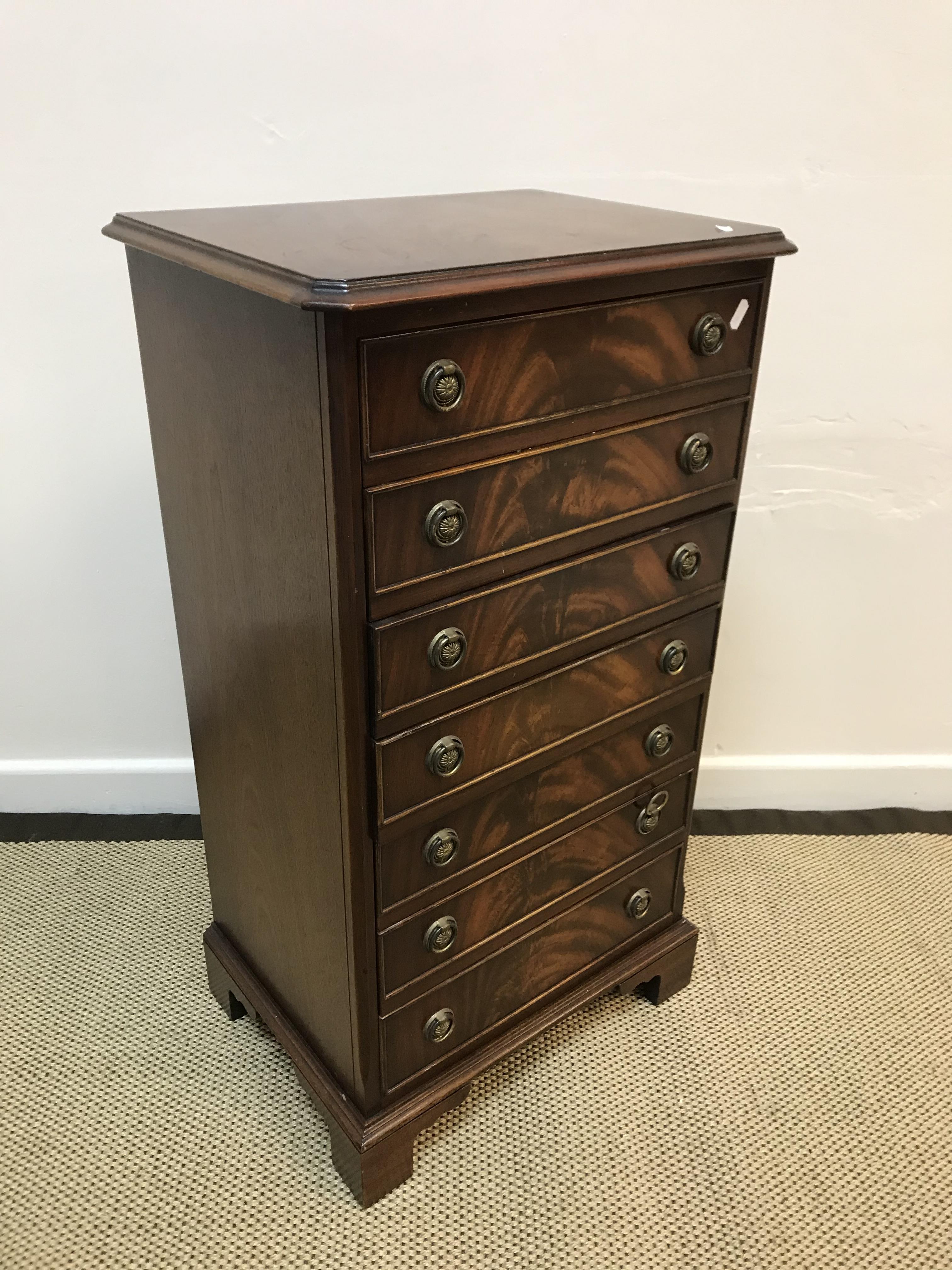 A Bevan Funnell Limited Reprodux mahogany music chest of seven drop front drawers with brass ring