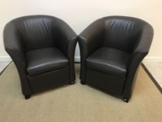A pair of modern brown leather upholstered tub chairs on squat square tapered feet,