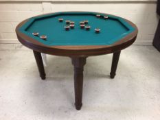 A modern mahogany "Bumper Pool" table, the circular top with baize playing surface on turned legs,