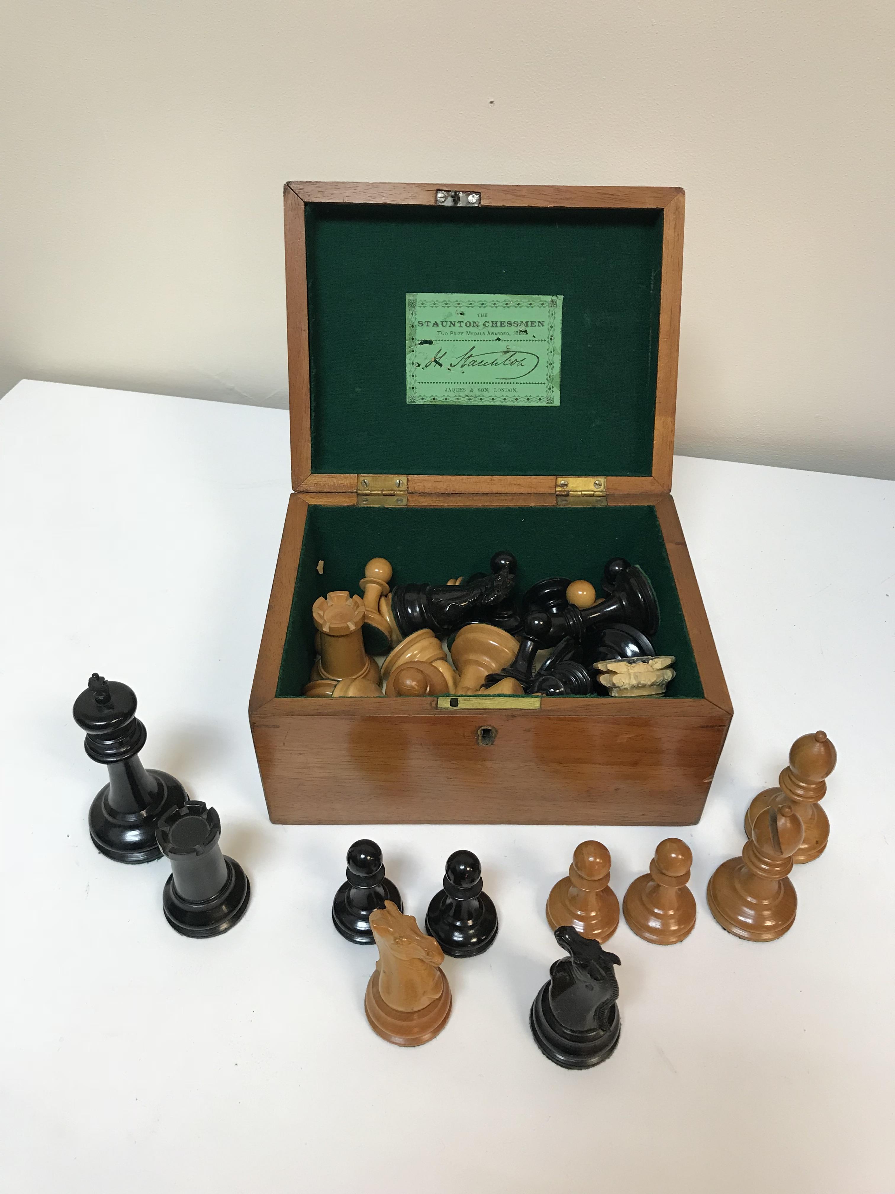 A Staunton chess set by Jacques & Son of London in boxwood and ebonised form (one rook with dog