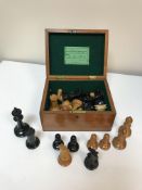 A Staunton chess set by Jacques & Son of London in boxwood and ebonised form (one rook with dog