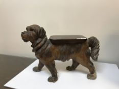 A black forest low stool in the form of a dog set with glass eyes,