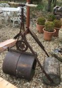 A Victorian cast iron garden roller with turned wooden handles,