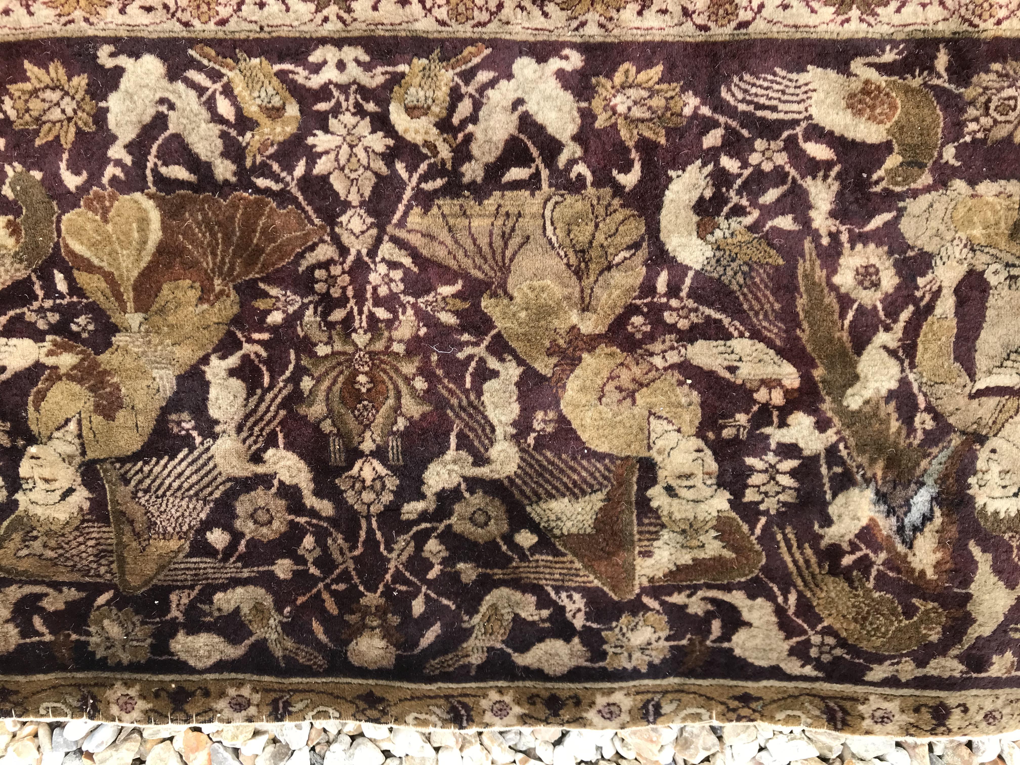 An early 20th Century Agra North India carpet with centre medallion on a wine-coloured ground, - Image 14 of 103