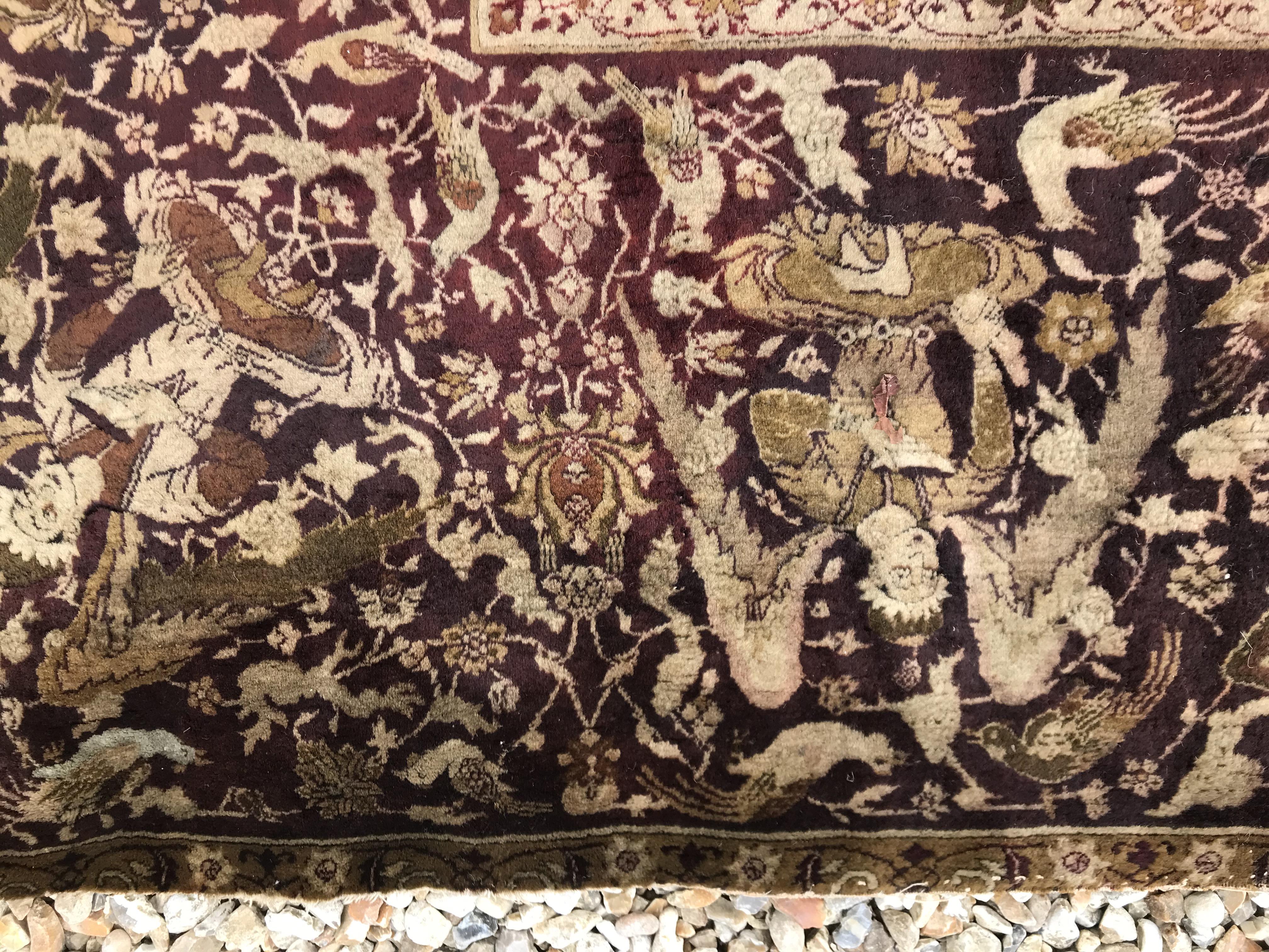 An early 20th Century Agra North India carpet with centre medallion on a wine-coloured ground, - Image 17 of 103