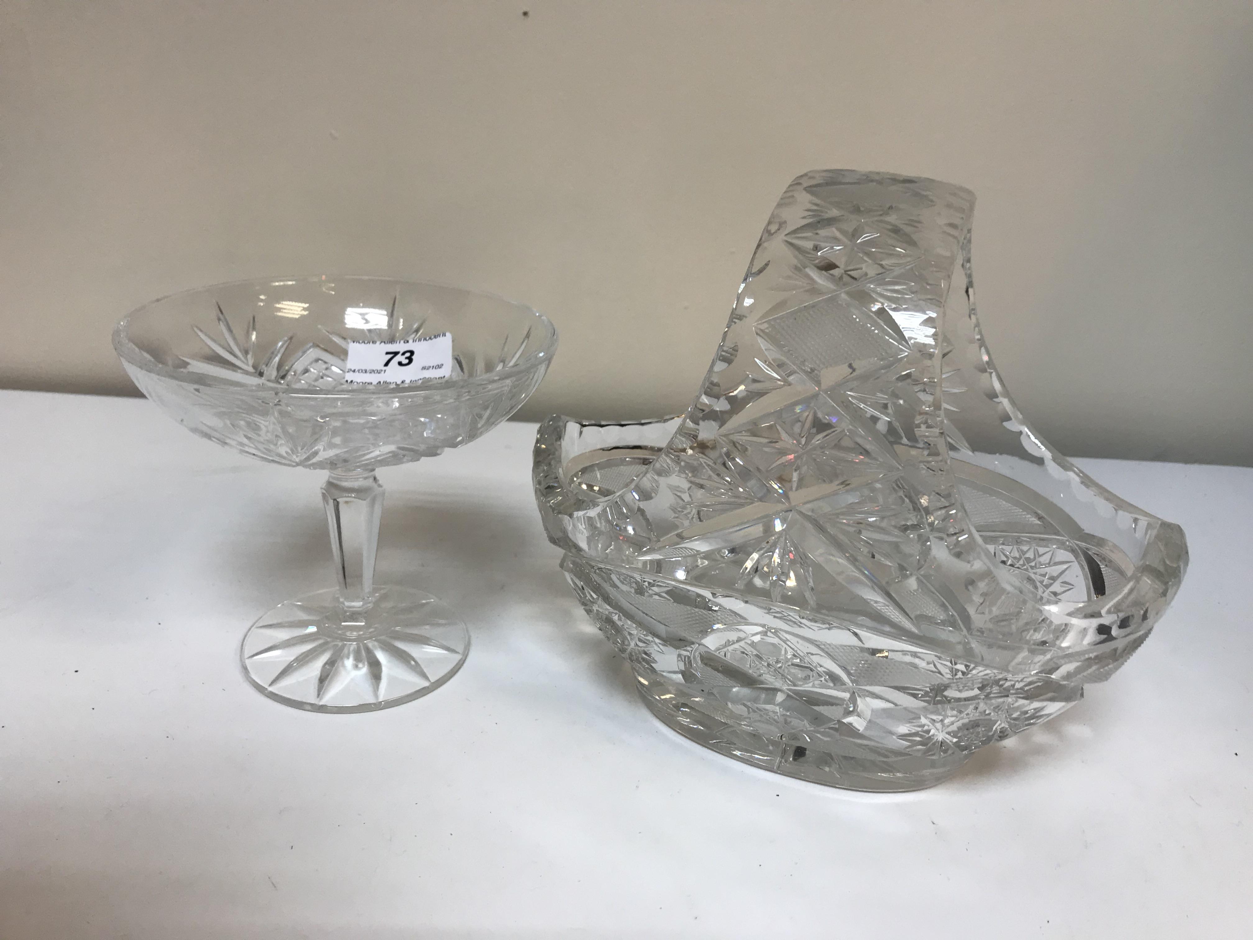 A collection of glassware to include a pair of slab cut jugs raised on pedestal feet,