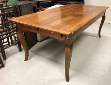 A modern oak farmhouse style kitchen table in the French manner attributed to I and JL Brown of