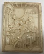 A 19th Century relief carved ivory panel depicting an interior scene with figures,