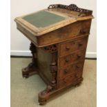 A Victorian walnut and inlaid Davenport desk with three quarter galleried top over a sloping