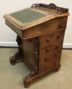 A Victorian walnut and inlaid Davenport desk with three quarter galleried top over a sloping