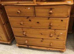 A modern pine chest of two short over three long graduated drawers,