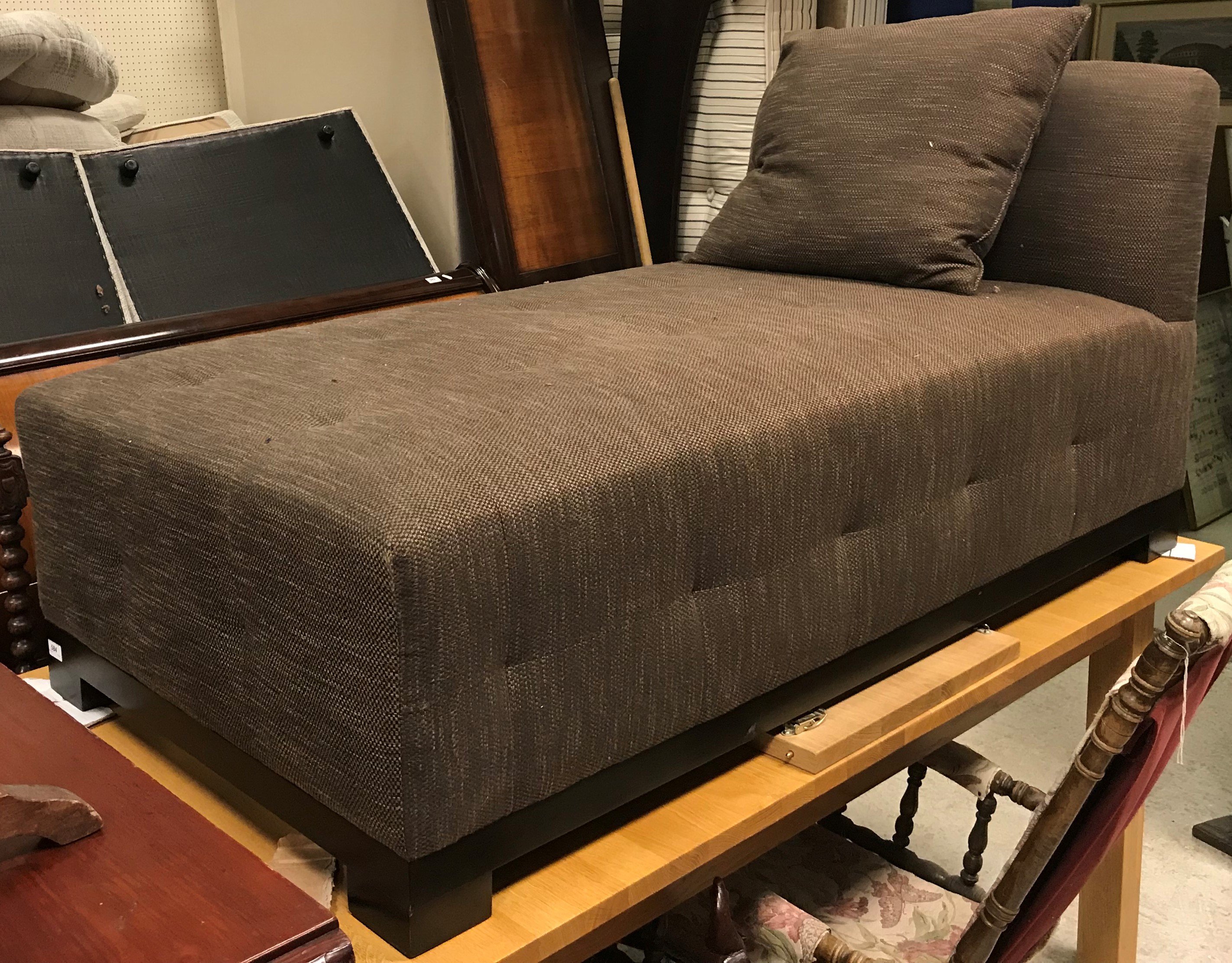 A modern upholstered day bed in dark brown fleck, raised on square block feet, 157.