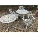 A modern painted metal circular garden table, the top with foliate design,