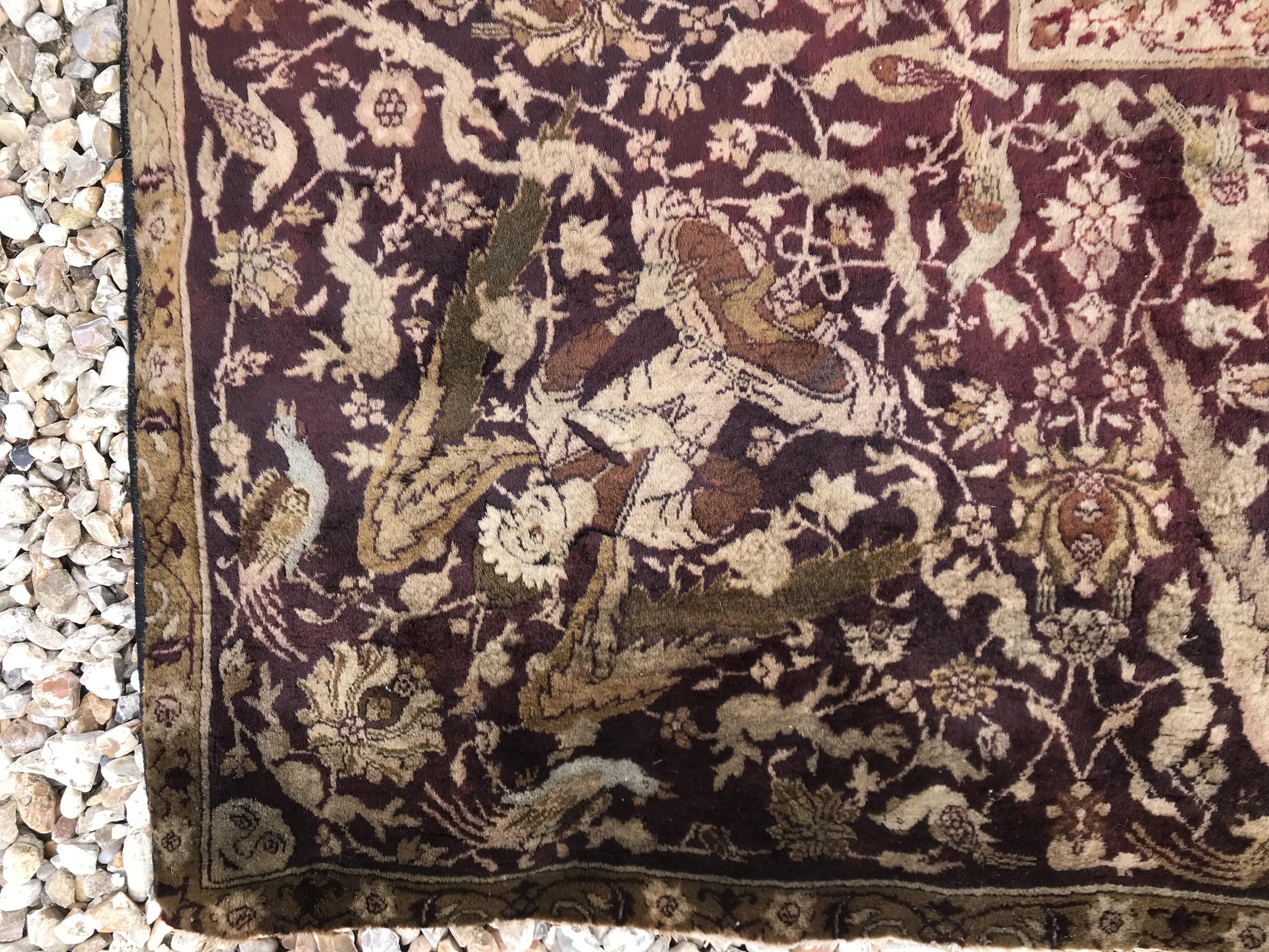 An early 20th Century Agra North India carpet with centre medallion on a wine-coloured ground, - Image 18 of 103